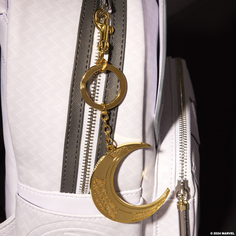 Limited Edition Loungefly Marvel Moon Knight Crescent Blade Keychain attached to the Mr. Knight mini backpack. The keychain is a gold crescent moon with engraved hieroglyphics.